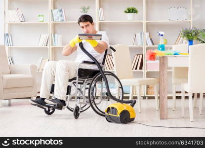 Disabled man with vacuum cleaner at home