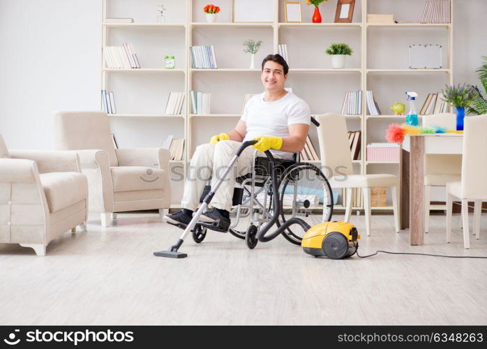 Disabled man with vacuum cleaner at home