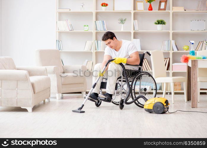 Disabled man with vacuum cleaner at home