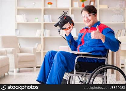 Disabled man working with handsaw at home