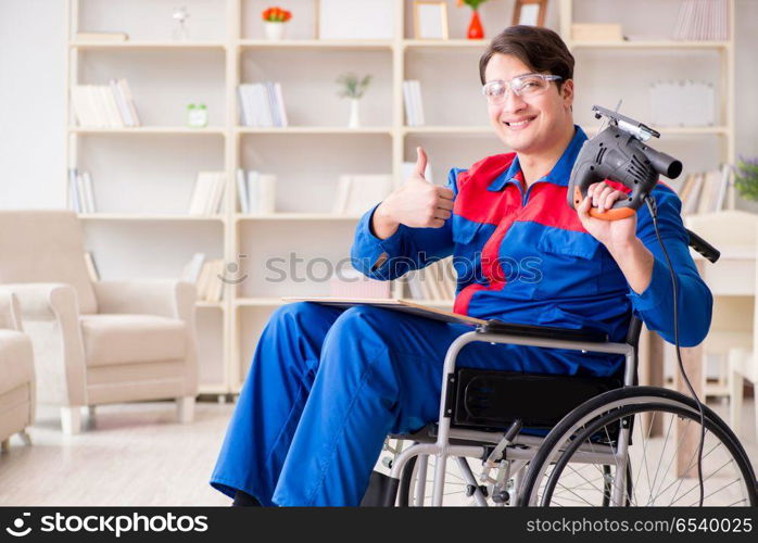 Disabled man working with handsaw at home