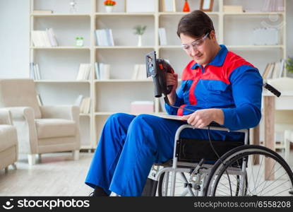 Disabled man working with handsaw at home