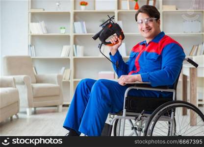 Disabled man working with handsaw at home