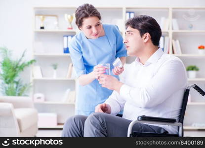 Disabled patient on wheelchair visiting doctor for regular check up. Disabled patient on wheelchair visiting doctor for regular check