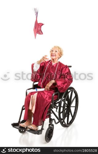 Disabled senior woman graduating college, tosses her cap in the air. Full body isolated on white.