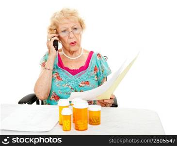 Disabled senior woman shocked by the cost of medical care and prescription medicine. White background.