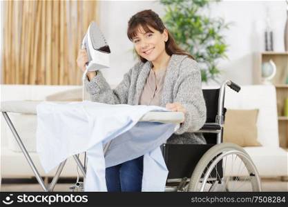 disabled woman during ironing at home