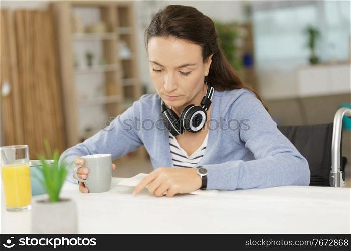 disabled woman holding her notebook while resting at home