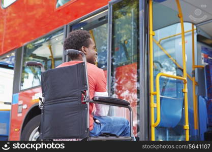 Disabled Woman In Wheelchair Boarding Bus