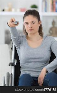 disabled woman in wheelchair watching movies at home