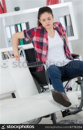 disabled woman trying to sit on sofa