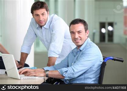 Disabled worker with colleague