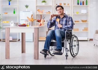 Disabled young man husband workin in kitchen