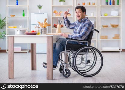 Disabled young man husband working in kitchen