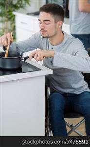 disabled young man in wheelchair in the kitchen