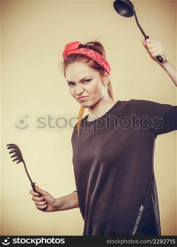 Disagreement in cooking. Kitchen accessories equipment in move. Girl having argument fight. Expression of anger.. Kitchen fight with retro girl.