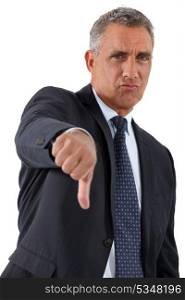 Disapproving businessman giving the thumb&rsquo;s down