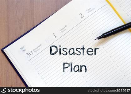 Disaster plan text concept write on notebook with pen