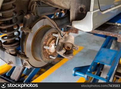 Disc brake of the car during the maintenance at auto service,closeup rear disc brake of the vehicle for repair.