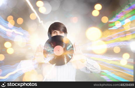 Disco dj. Young handsome man dj holding disco plate