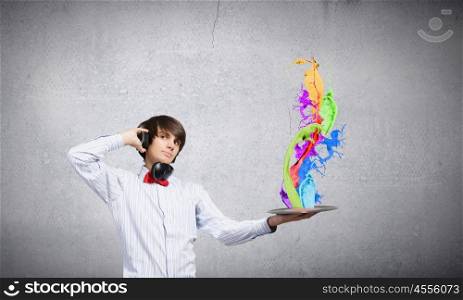 Disco dj. Young man dj wearing headphones and holding plate
