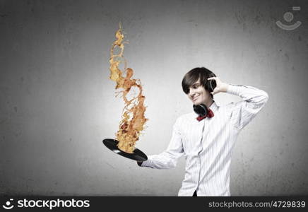 Disco party. Young handsome man with disco plate in hands