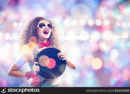 Disco party. Young pretty girl dj at disco party holding vinyl
