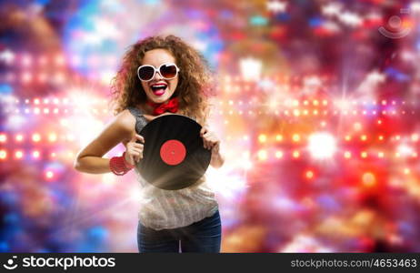 Disco party. Young pretty girl dj at disco party holding vinyl