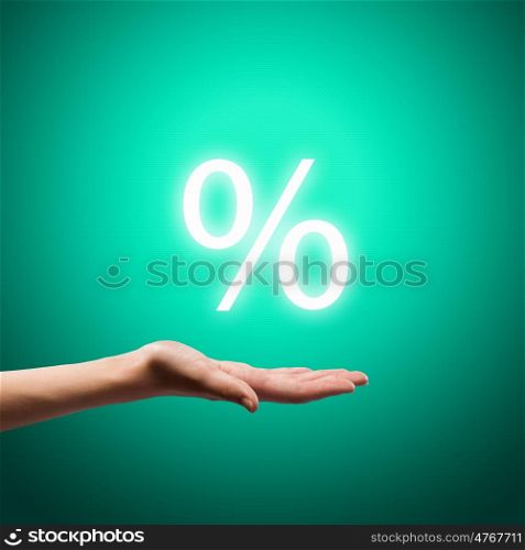 Discount symbol. Close up image of human hand holding sales sign