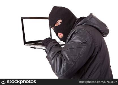 Disguised computer hacker with laptop