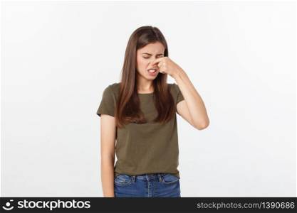 disgusted young blonde closing her nose with her fingers. Isolated over white background. disgusted young blonde closing her nose with her fingers. Isolated over white background.