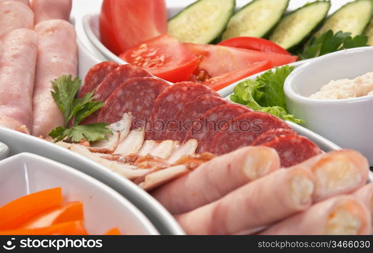 dish of assorted sausages and vegetables