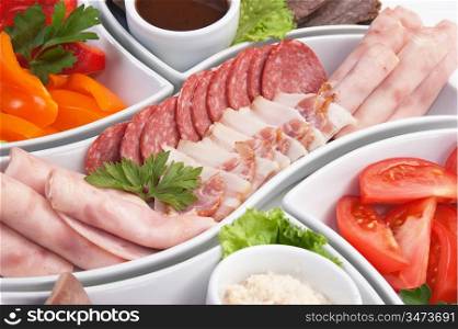 dish of assorted sausages and vegetables