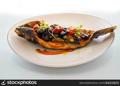 Dish of baked bream with vegetables in a gourmet restaurant