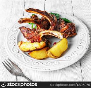 dish of baked lamb ribs. fragrant roast of lamb chops on the plate