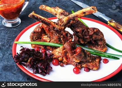 dish of baked lamb ribs. fragrant roast of lamb chops on the plate