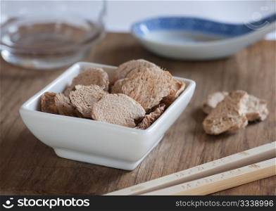 Dish of Dried Galangal Slices, Ready To Be Used For Cooking An Asian meal.