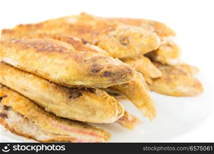 Dish of fried fishes red mullets isolated on white background