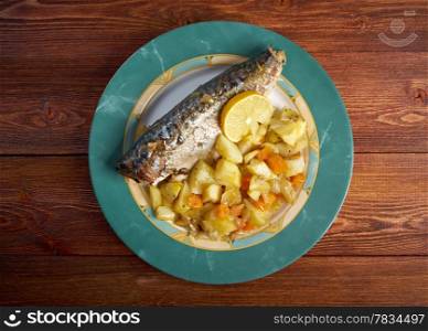 Dish of grilled mackerel and potatoes . closeup farmhouse kitchen
