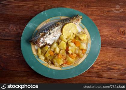Dish of grilled mackerel and potatoes . closeup farmhouse kitchen