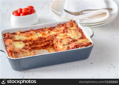 Dish of lasagne on white background