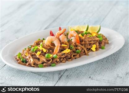 Dish of Pad Thai - Thai fried rice noodles on the wooden background