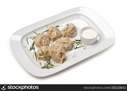 dish of ravioli with sour cream isolated on white background