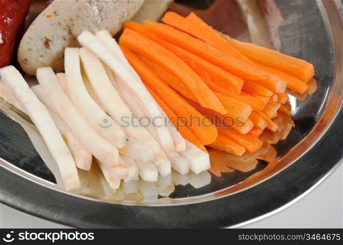 dish of sliced carrots and vegetables