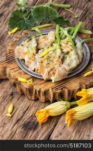 Dish of Zucchini flowers. Edible zucchini flower stuffed with soft cheese with herb