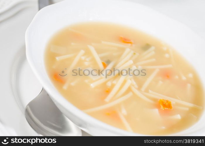 Dish soup with noodles and diced vegetables