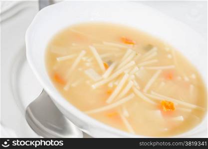 Dish soup with noodles and diced vegetables
