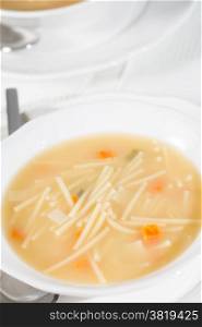 Dish soup with noodles and diced vegetables
