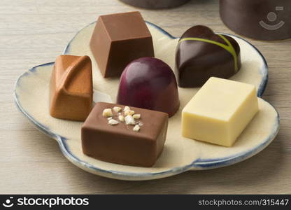 Dish with assorted chocolate bonbons for dessert