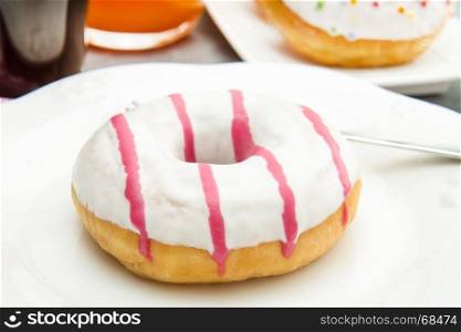 dish with assorted donuts, coffee and juice